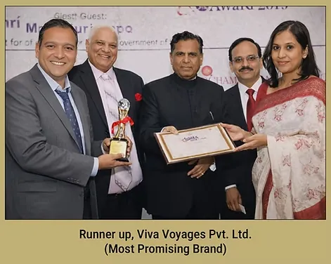 Vikas Khanduri receiving a trophy and certificate on stage