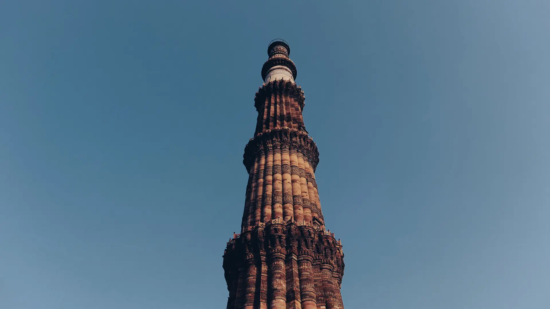 Looking up at the fluted sandstone tower of the Qutub Minar in New Delhi