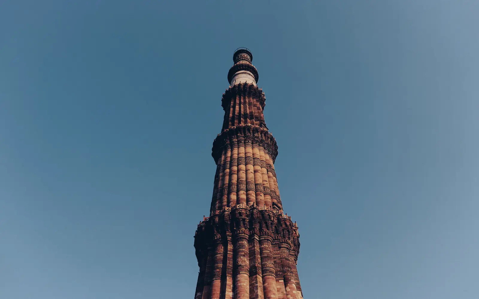 Looking up at the fluted sandstone tower of the Qutub Minar in New Delhi