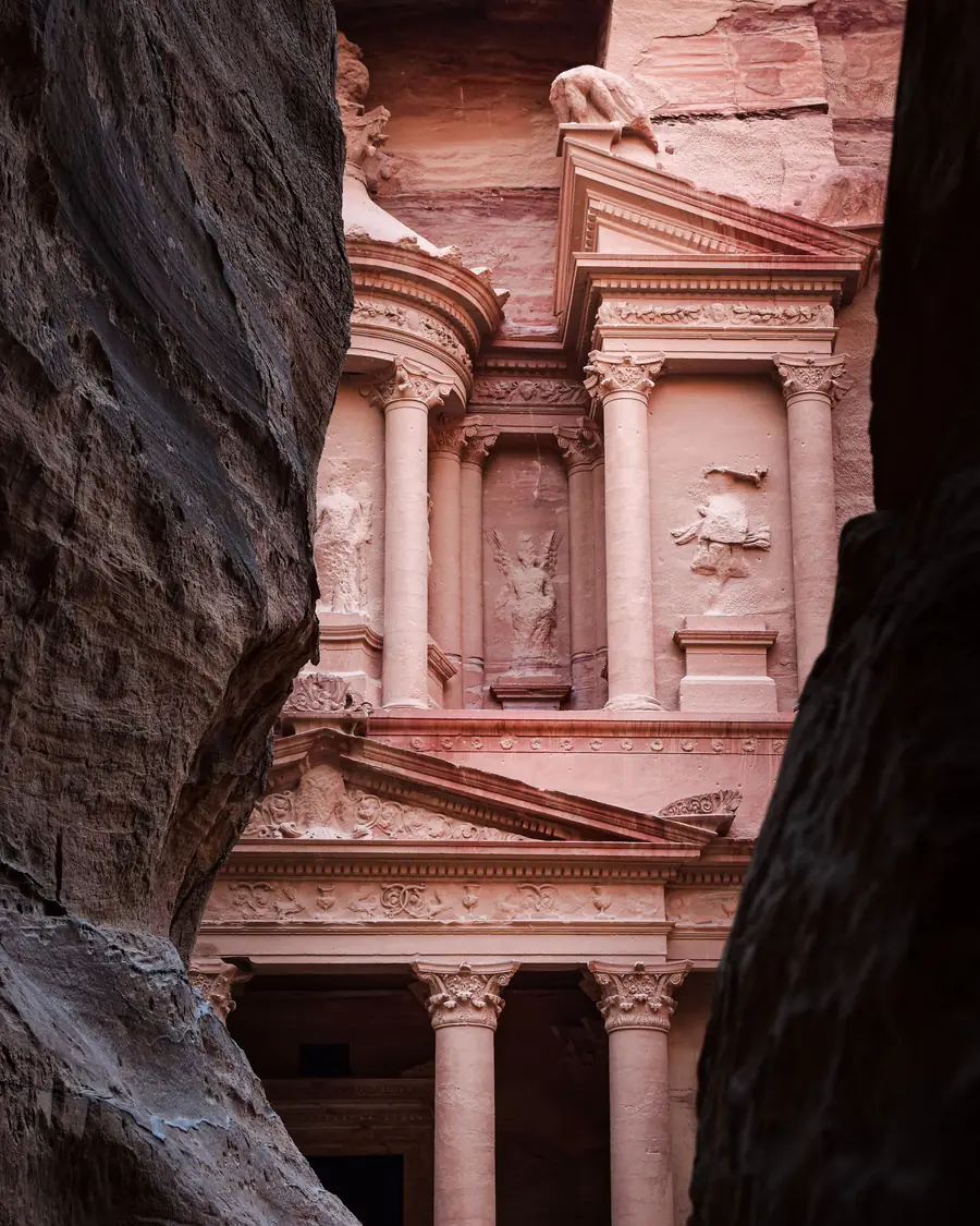 The Treasury at Petra seen through the narrow walls of the Siq, Jordan